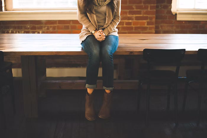 Woman sitting on a table.